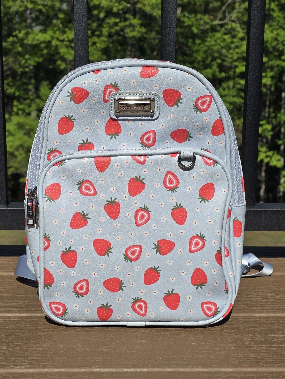 Madden Girl mini backpack with strawberry print and light blue background.